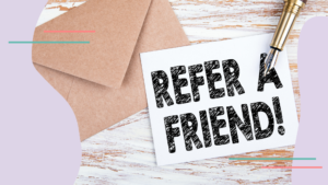 An envelop on a table with a note that says "refer a friend!"