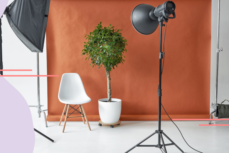 A product photoshoot is set up with lights focused on a chair and plant.